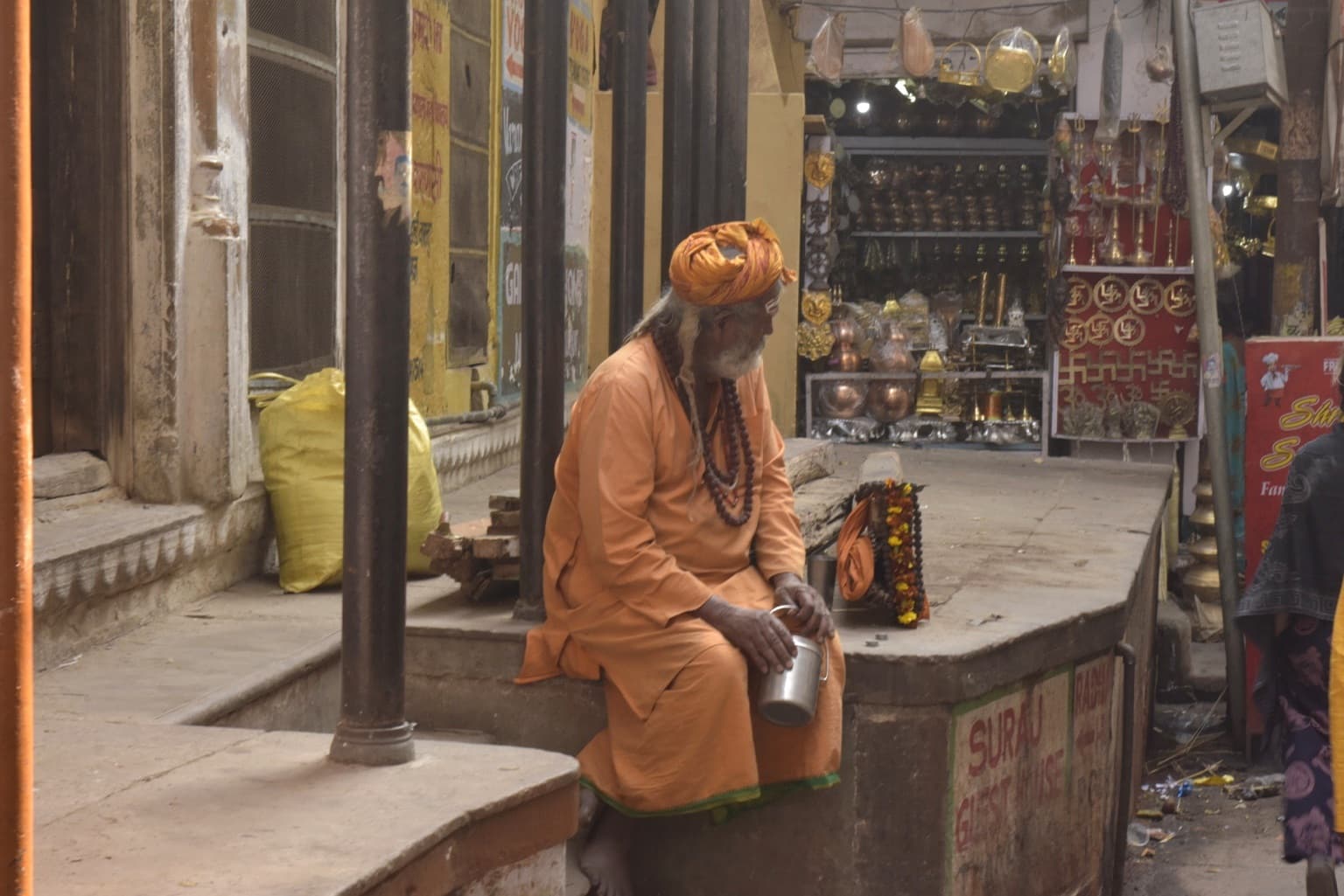 A sadhu is observed amid the activity of the ghats during the 2019 return to Varanasi.