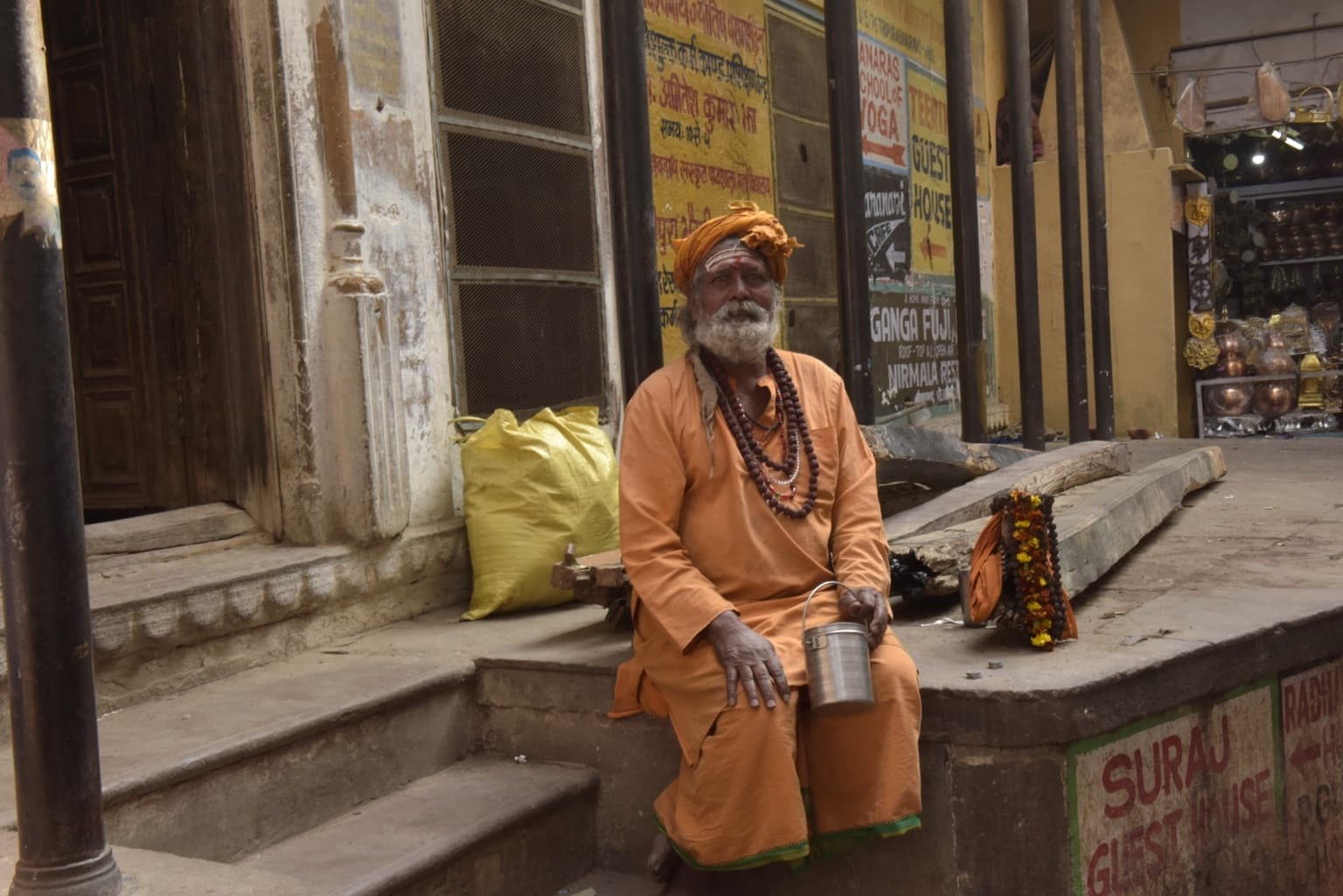 A seated sadhu looks directly toward the camera during an encounter on the ghats of Varanasi, 2019.