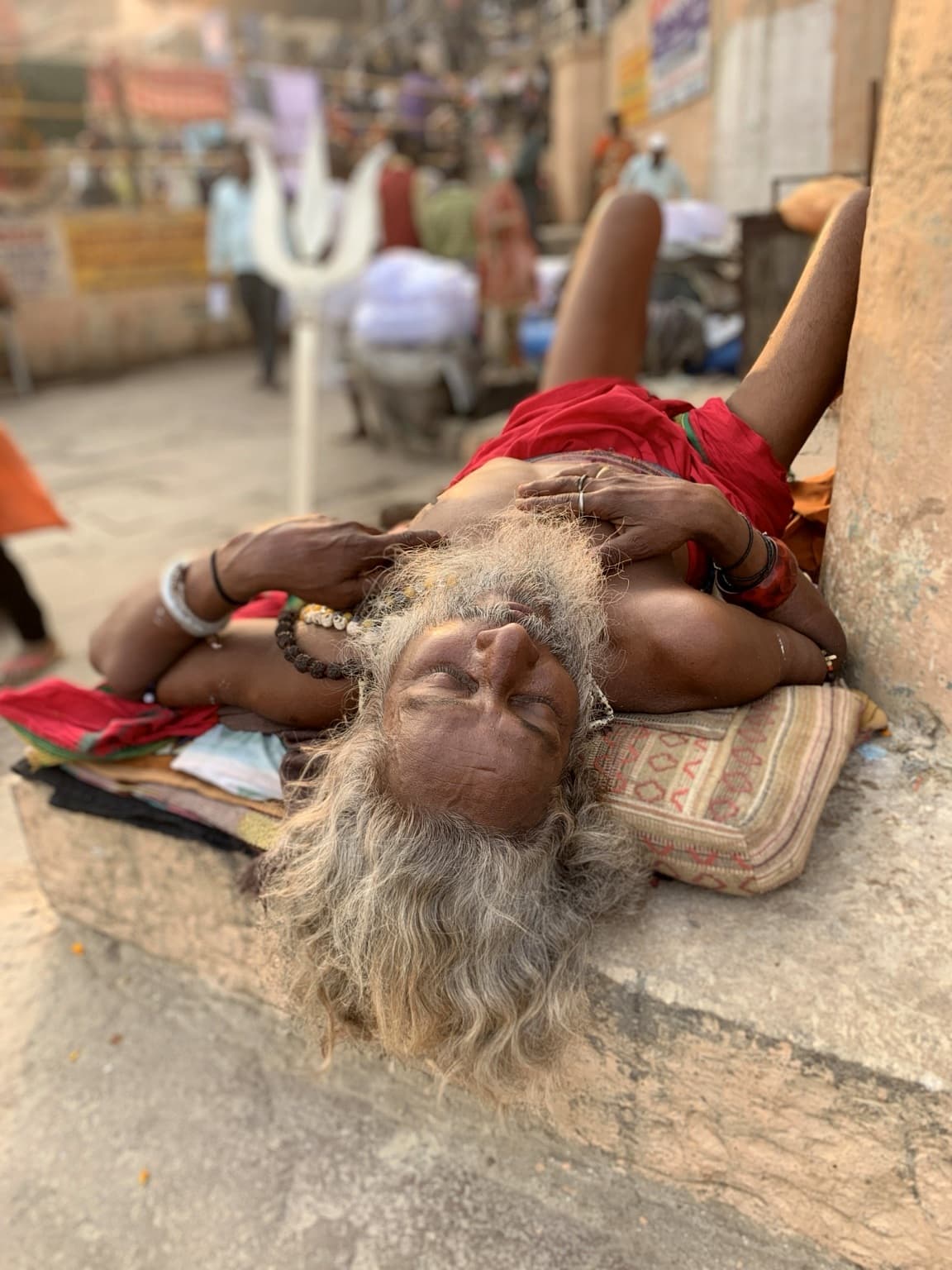 A figure moves through the riverfront scene on the ghats of Varanasi, 2019.