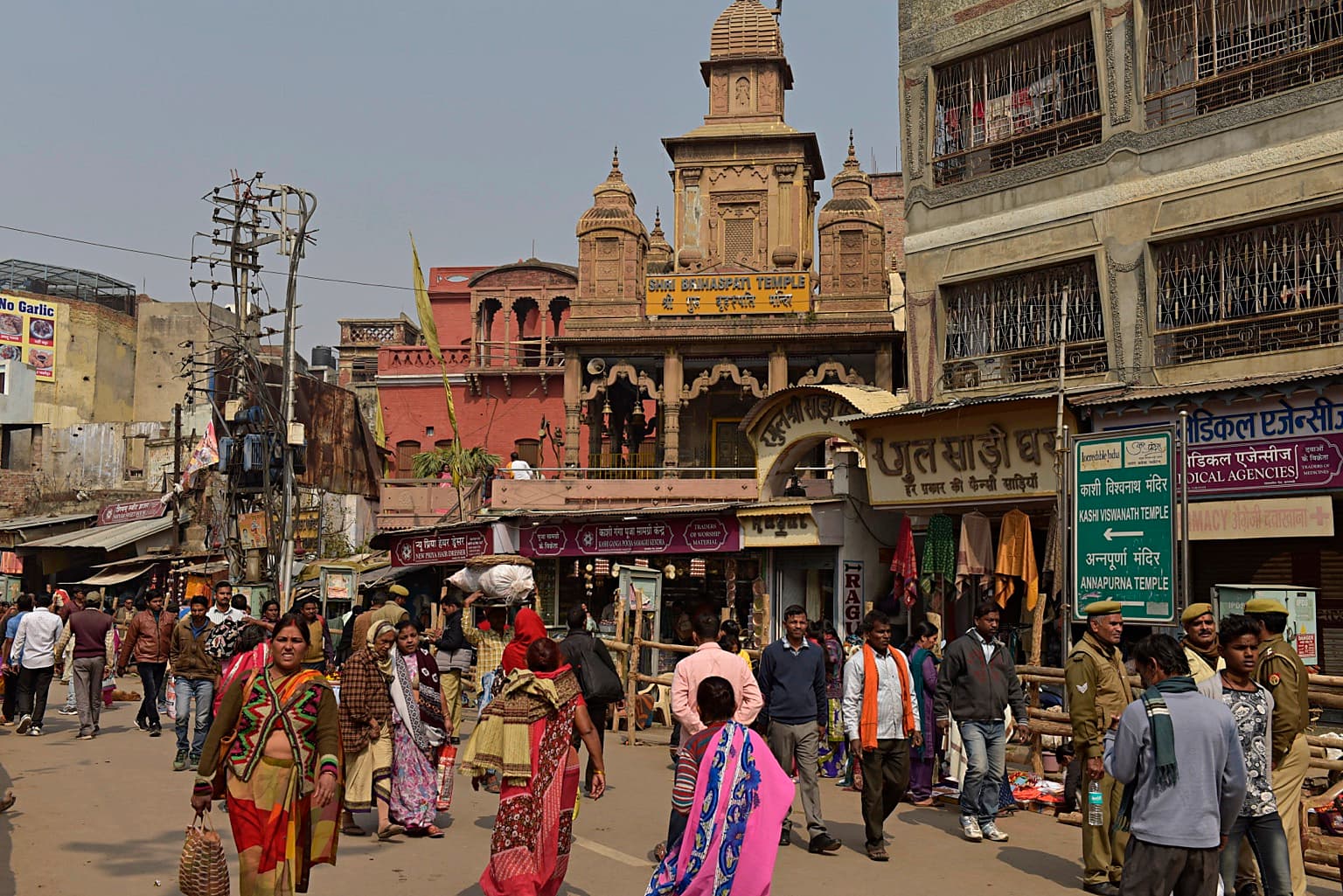 Pedestrians move through a busy street near Shri Brihaspati Temple in Varanasi, 2019