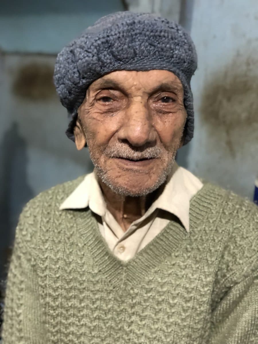 The man facing the camera in a second portrait at the tea stall.