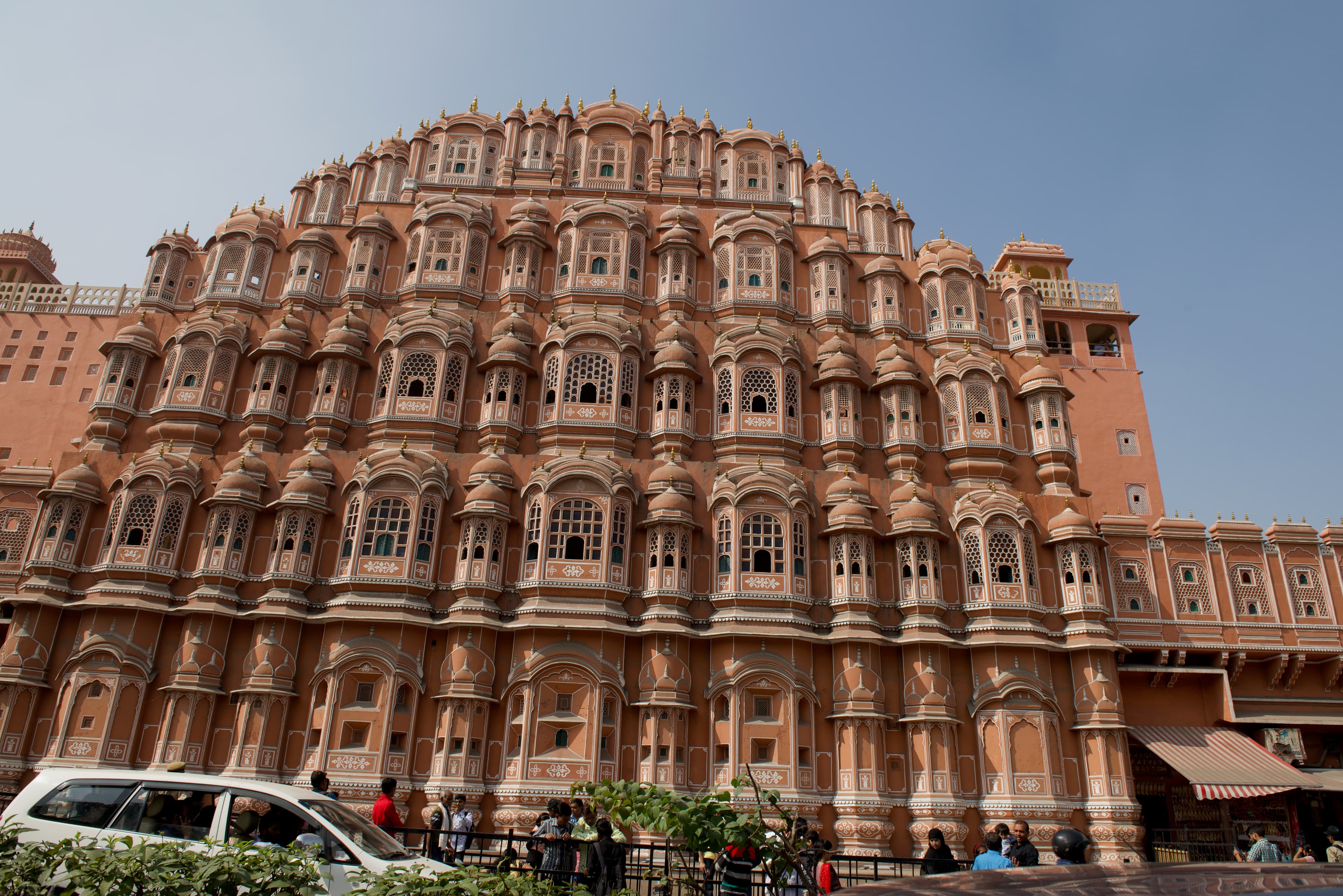 The many windows and projecting bays of Hawa Mahal rise above Jaipur’s street.